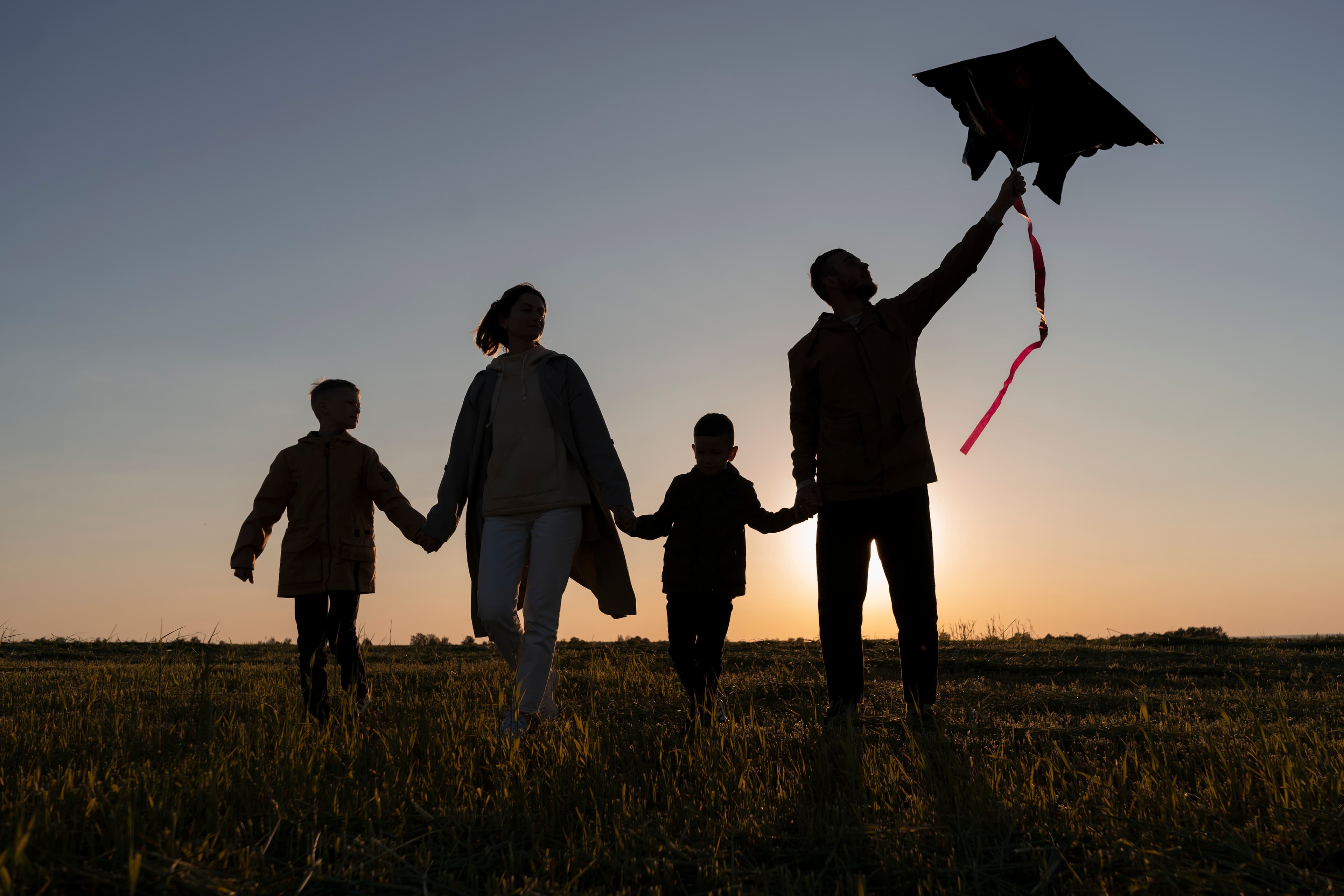 Family walking at sunset